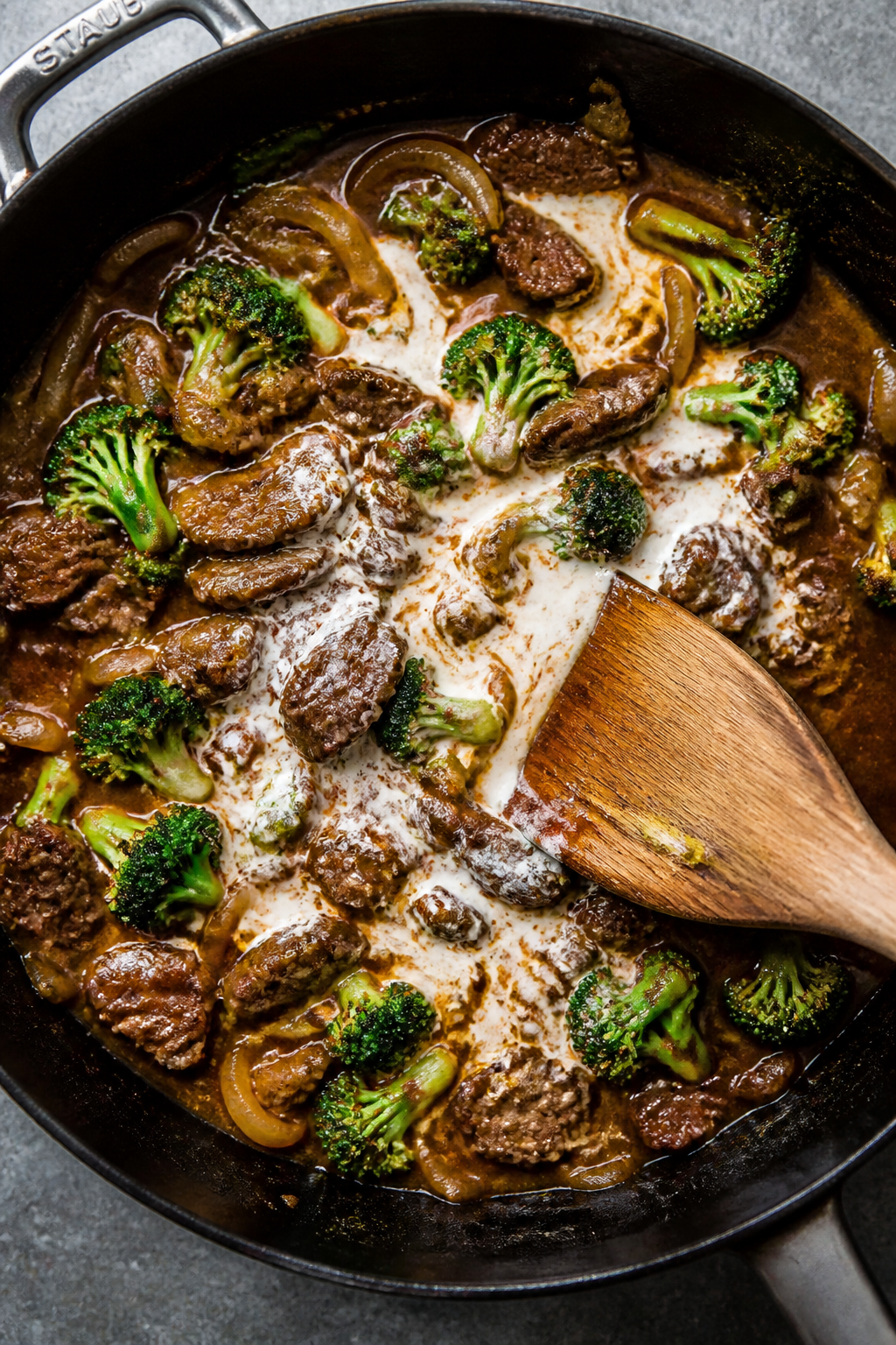 Cooking process: Overhead shot of the Cheesy Beef & Broccoli Skillet mid-simmer after deglazing—be