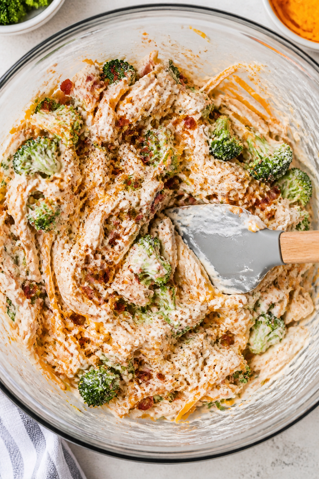 Cooking process: Overhead shot of the creamy base being folded together in a large mixing bowl—shr