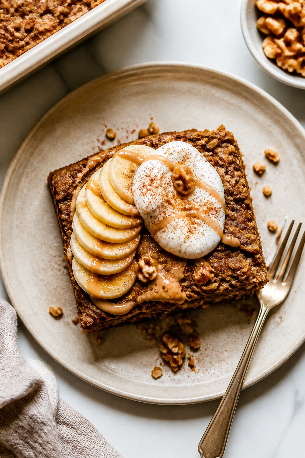 Final plated dish: Beautifully plated square of protein-packed banana bread baked oats (from an 8x8