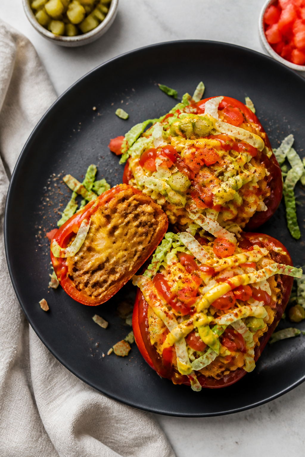 Final plated dish: Restaurant-quality presentation of cheeseburger stuffed peppers on a matte charco