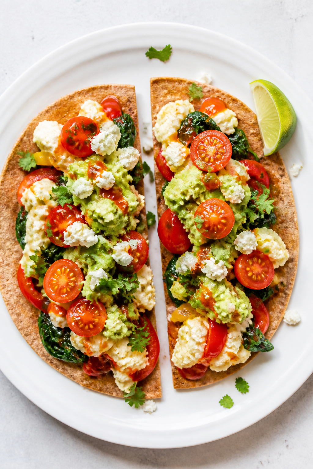Overhead tasty top view: Loaded Egg White Breakfast Wrap sliced in half, shown open-faced before rol