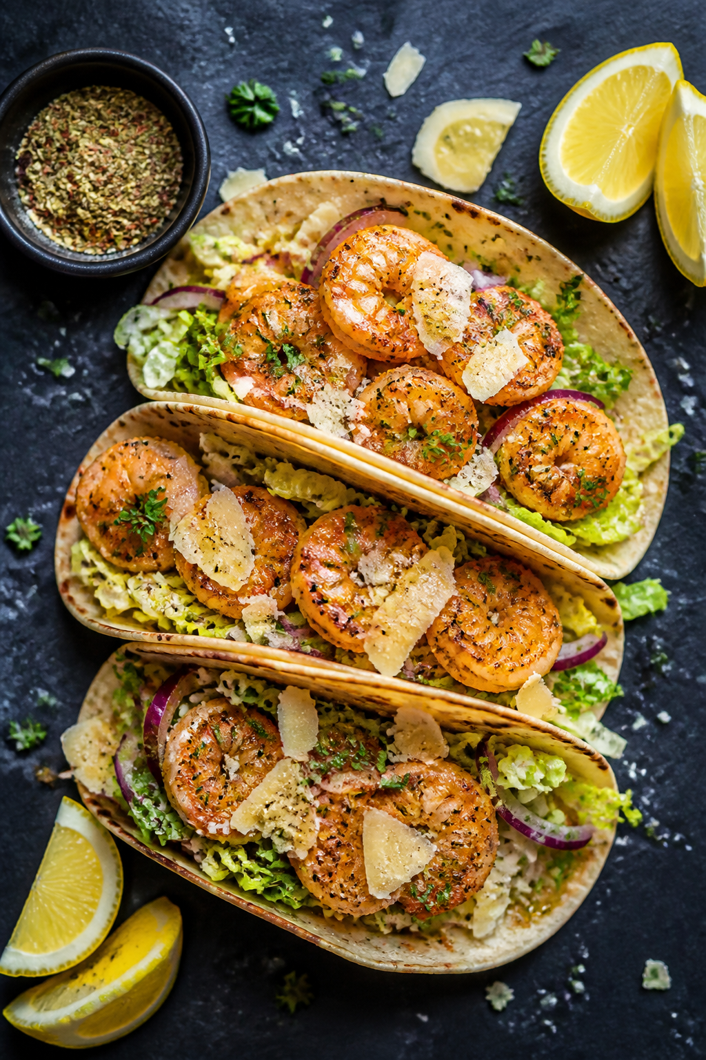 Overhead “tasty top view” of shrimp taco variation: warm tortillas filled with crispy-edged garl