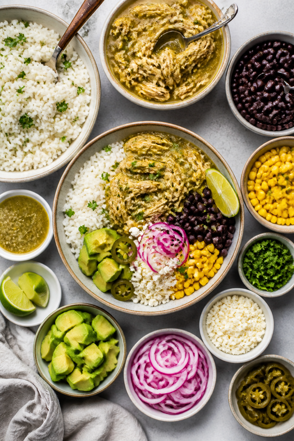 Tasty top view, assembly moment: Overhead shot of a build-your-own Salsa Verde Chicken Rice Bowl spr