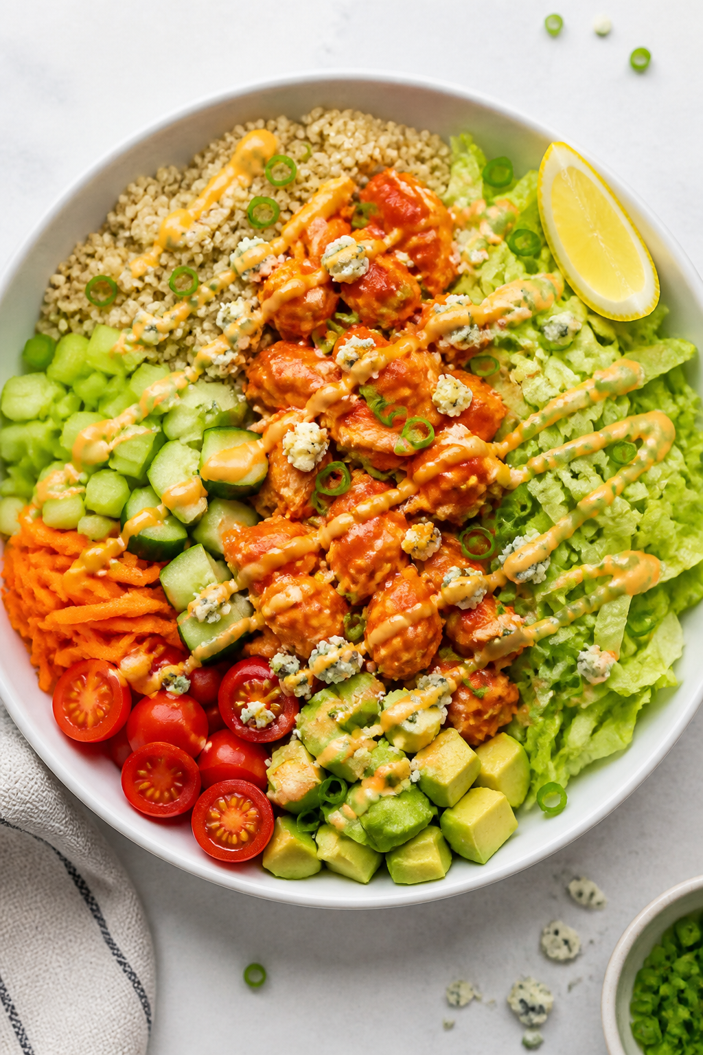 Tasty top view: Overhead shot of assembled High Protein Buffalo Chicken Bowl on a wide white shallow