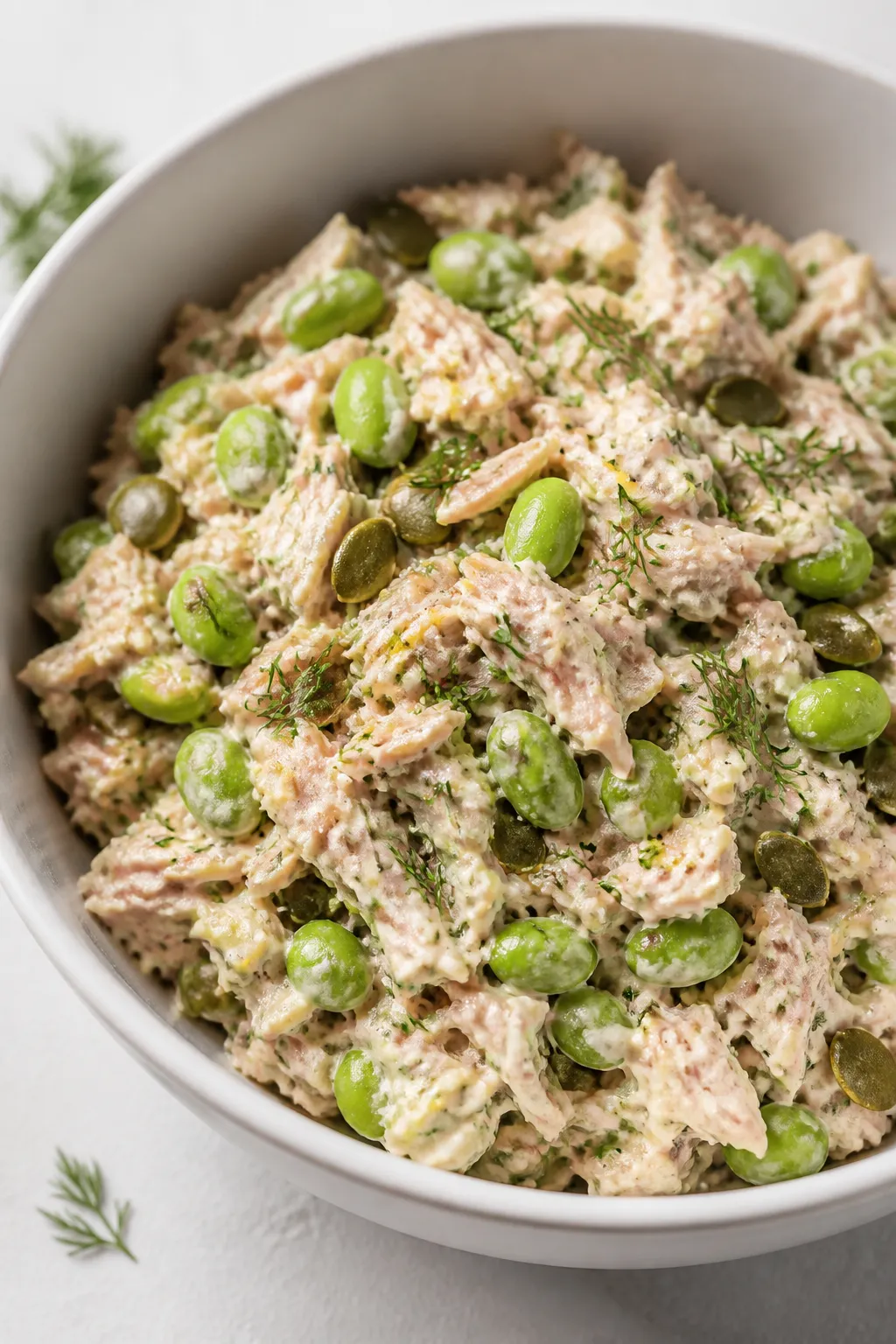 Close-up detail: Flaked tuna mixed with Greek yogurtâlemonâDijon dressing and edamame in a matte