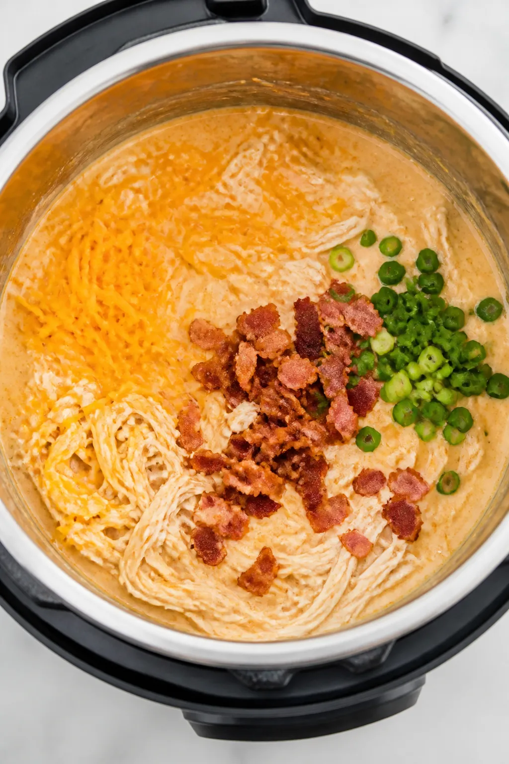 Cooking process: Instant Pot just opened with hot, shredded chicken being stirred back into a velvet