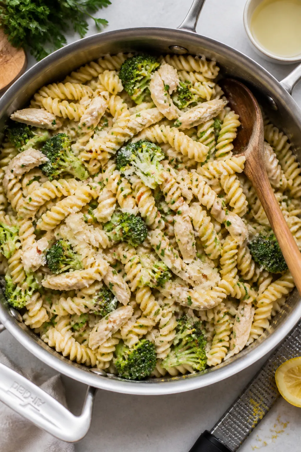 Tasty hearty serving: Overhead shot of a large skillet tossed with rotini coated in glossy garlic-Pa
