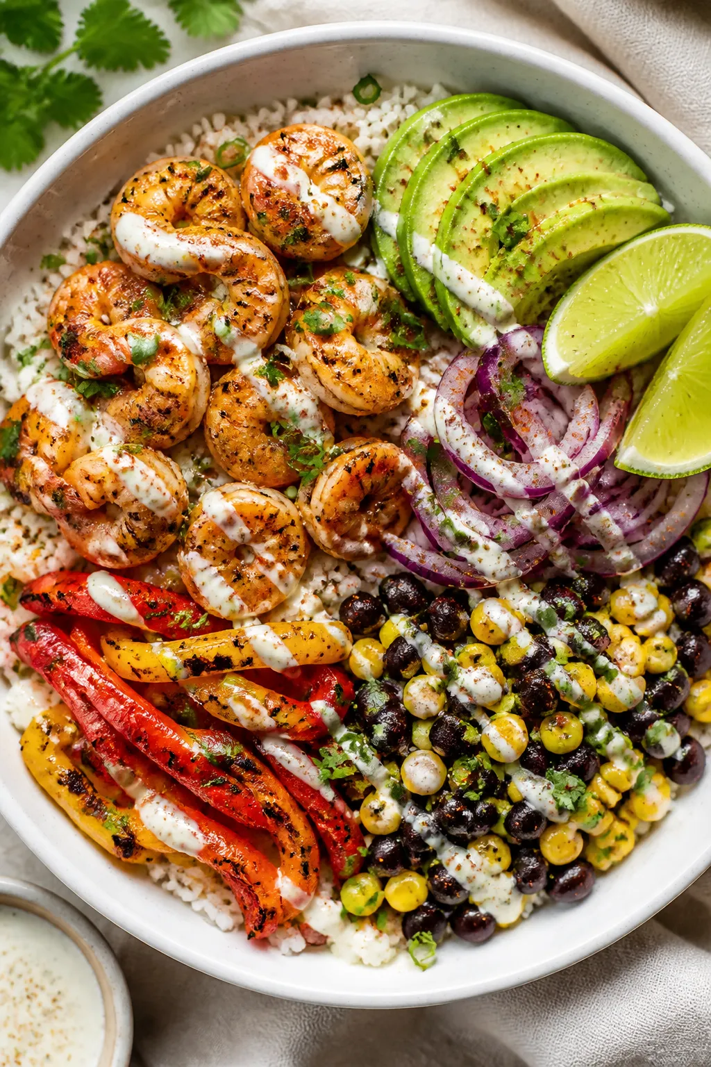 Tasty top view: Overhead shot of assembled High Protein Cajun Shrimp Rice Bowl—fluffy jasmine rice